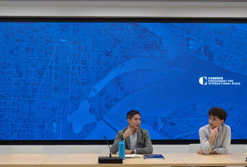 Steve Feldstein and Adrian Feinberg, '25, present to the group at the Carnegie Endowment for International Peace.