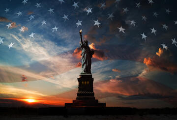 Sunset with overlaid American flag and Statue of Liberty