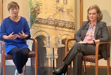 Ema Yamazaki and Katherine Monahan seated on stage during a fireside chat.
