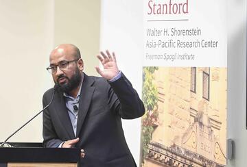 Tasneem Khalil delivers remarks at a lectern.