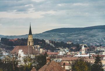 Brown and white concrete building under white clouds during daytime