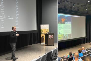 Steven Schwankert on a theater stage at a screening and discussion of the documentary 'The Six.'