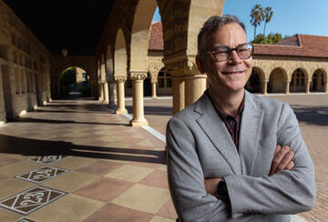 Colin H. Kahl under the arches of Stanford's main quad