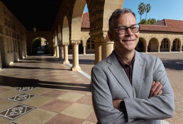 Colin H. Kahl under the arches of Stanford's main quad