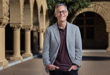 Colin H. Kahl standing in Stanford's main quad