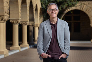 Colin H. Kahl standing in Stanford's main quad