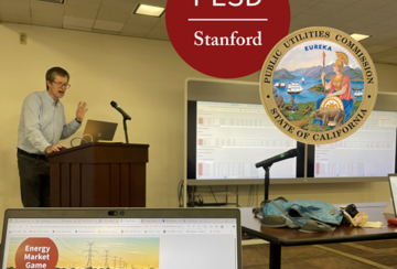 Mark Thurber teaching with Energy Market Game computer screen in foreground