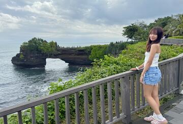 a person standing in front of Tanah Lot