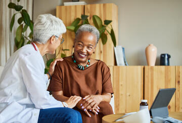 An elderly physician and patient