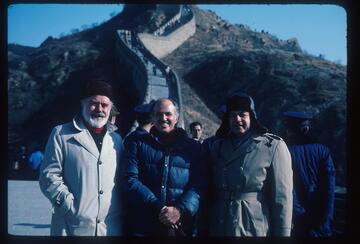 three people standing at the great wall in China
