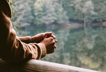 A photo of a person overlooking water
