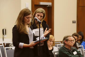 Students from Stanford's Law and Policy Lab speak at a microphone
