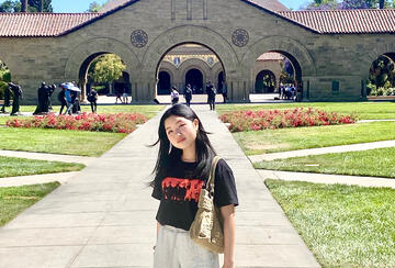 a student in front of Memorial Church during a summer program at Stanford University