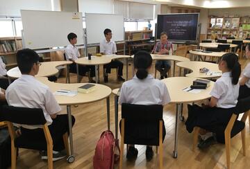 students and an instructor sitting in a circle in a classroom