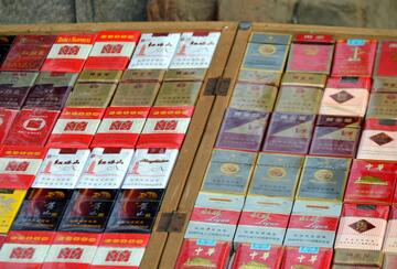 Rows of Chinese cigarette packs on display for sale.