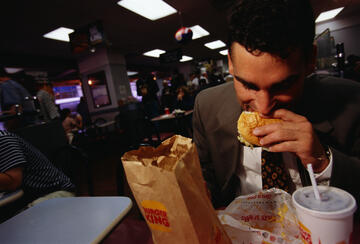 A man eating a hamburger at Burger King