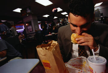 A man eating a hamburger at Burger King