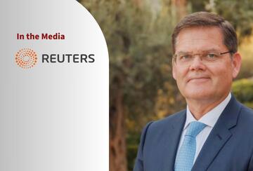 Portrait of Curtis Milhaupt and a logo of Retuers.