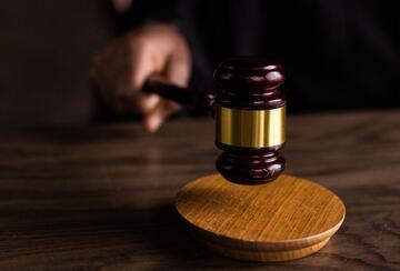 Brown wooden gavel on brown wooden table