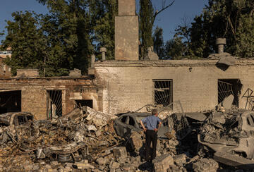 Residents walk through debris in a courtyard following a Russian missile strike on August 20, 2026, in Kyiv, Ukraine.