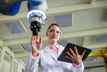 A woman doctor or engineer at a medical device and tablet