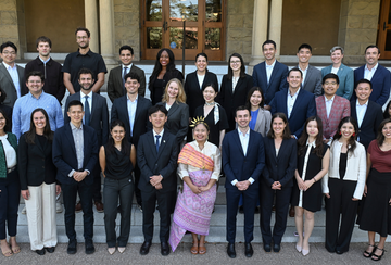 A group photo of the Class of 2028 of the Ford Dorsey Master's in International Policy on the front steps of Encina Hall at Stanford University.