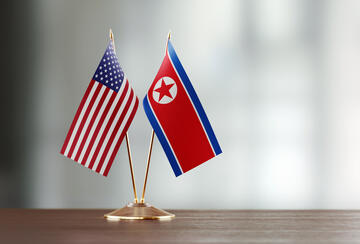 U.S. and DPRK Flags on Table