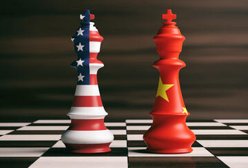 US-China relations concept: US and China flags on chess kings on a chess board, brown wooden background. 3d illustration.