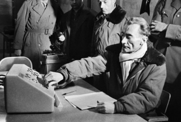 Director of nuclear experiment center, General Jean Thiry, pressing a button to trigger the explosion of the third French atomic bomb at the Reggane test site in the Algerian Sahara, December 27, 1960