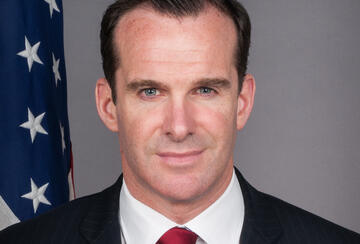 picture of man with American flag in the background