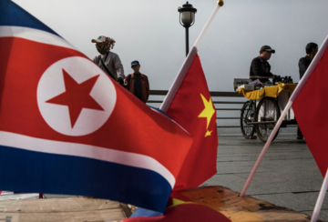 Small flags of North Korea and China for sale near the China-North Korea border