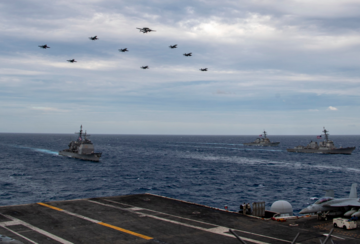 Aircraft assigned to the Theodore Roosevelt Carrier Strike Group fly over the South China Sea