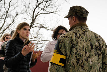 Student Isabelle Foster asks Lieutenant Commander Daniel McShane about his time defending the DMZ as they stand on a platform overlooking North Korea. Photo by Nicole Feldman.