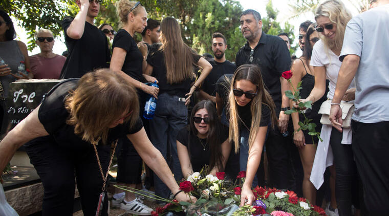 Family and friends of May Naim, 24, who was murdered by Palestinians militants at the "Supernova" festival, near the Israeli border with Gaza strip, react during her funeral on October 11, 2023 in Gan Haim, Israel. (Getty Images)
