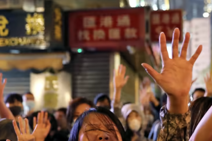 Protesters sing "Glory to Hong Kong" outside of Hong Kong Polytechnic University in 2019 while police lay siege.  