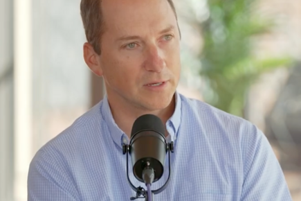 David Lobell Seated before Microphone
