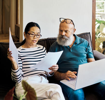 Couple looks at bills with concern
