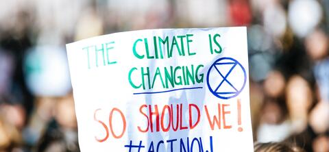 handwritten sign for climate action