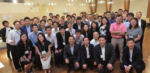 Alumni of APARC's Global Affiliates Program pose for a group photo in an indoor space, Tokyo, Japan, 2018.