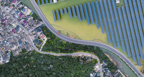 Solar power station above a lake and next to a residential town in Suzhou, China.