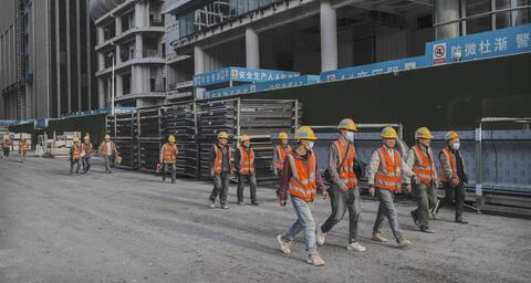 Construction workers leave a work site in the Central Business District on April 10, 2025 in Beijing, China. 