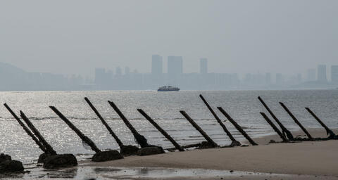 he Chinese city of Xamen is seen in the distance behind aged anti-landing barricades on a beach facing China on the Taiwanese island of Kinmen which, at points lies only a few miles from China, on April 19, 2018 in Kinmen, Taiwan. 