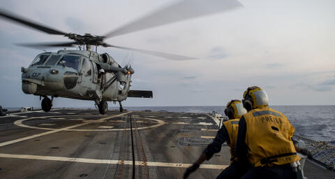 U.S. Navy Boatswain’s Mate Seaman Louie Beasley, Jr., from Oklahoma City, directs an MH-60S Sea Hawk, assigned to Helicopter Sea Combat Squadron (HSC) 25, while landing on the flight deck of the guided-missile destroyer USS Preble (DDG 88) during deck lan