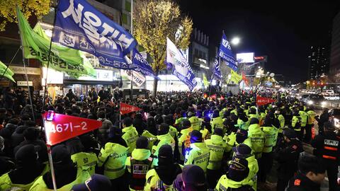 Protesters demonstrate against the country's president as police stand guard on December 04, 2024 in Seoul, South Korea.