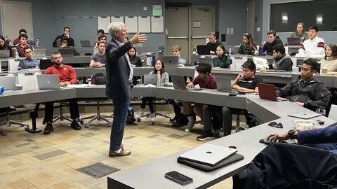 Man lectures before a clasroom