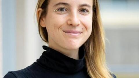 Headshot of Romina Wainberg. Wainberg wears a black turtleneck