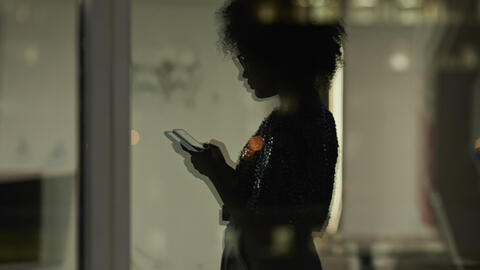 teenager looking down at phone