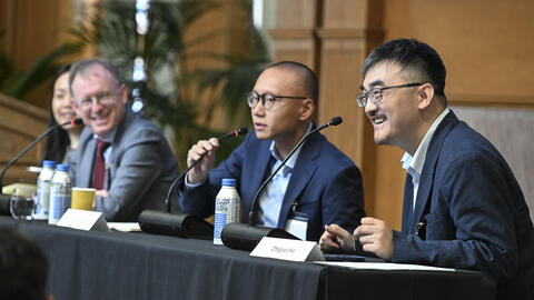 Panelists speak during a session at the 2025 SCCEI China Conference.