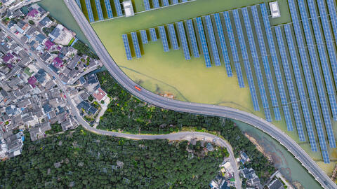 Solar power station above a lake and next to a residential town in Suzhou, China.