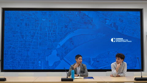 Steve Feldstein and Adrian Feinberg, '25, present to the group at the Carnegie Endowment for International Peace.
